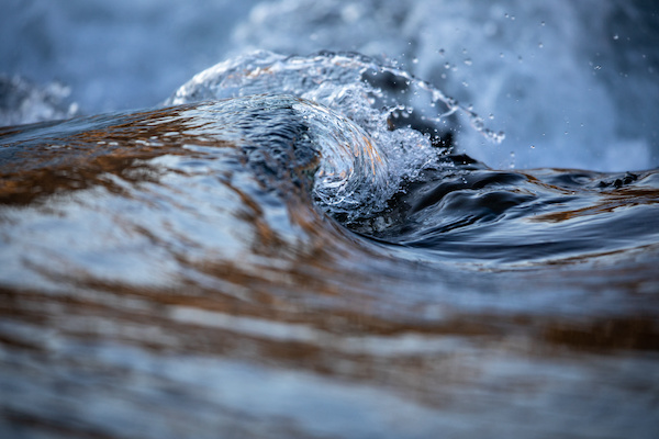 water concept river water flowing with light reflecting of its surface